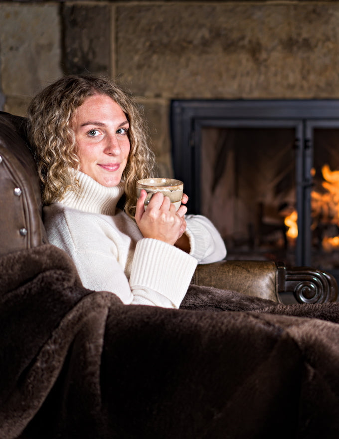 Sheared Beaver Fur Blanket, model near fireplace