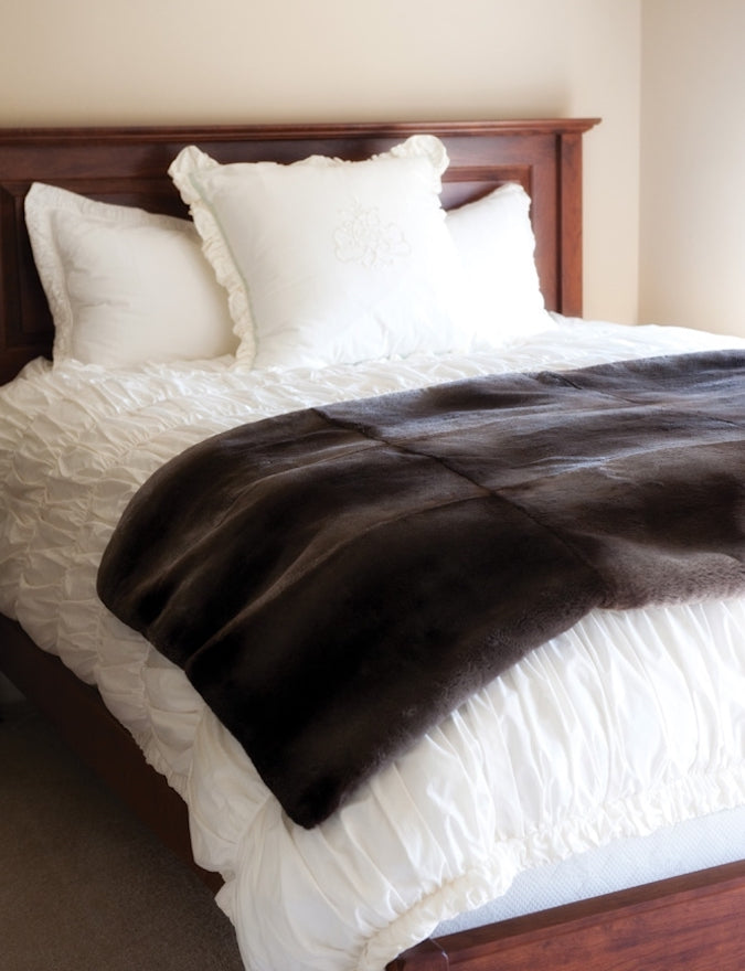 Custom Fur Blankets folded on bed